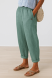 Women's linen pants featuring an elastic waistband and tapered design, perfect for casual wear; breathable and lightweight fabric ideal for warm weather. 3