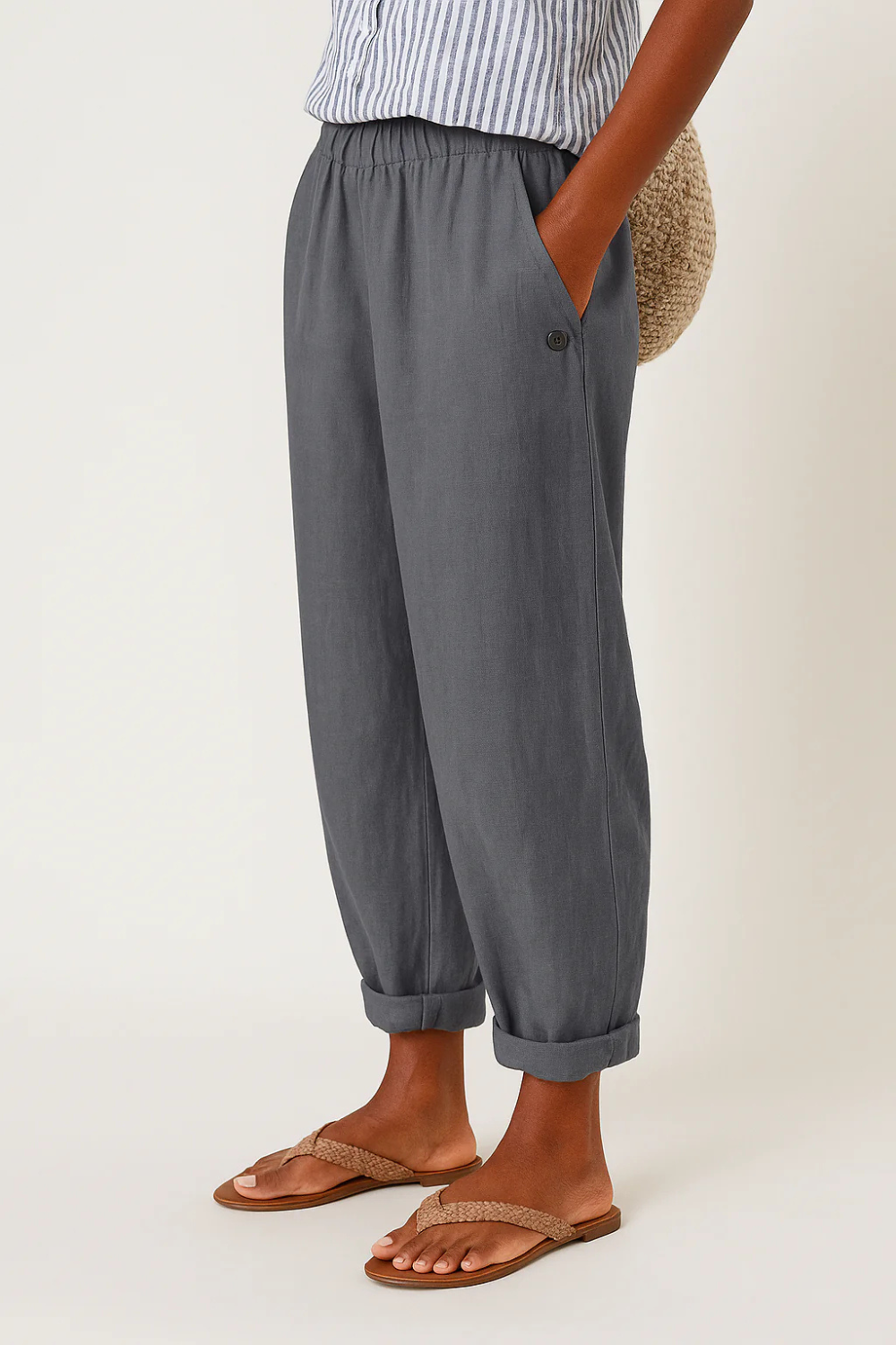 Women's linen pants featuring an elastic waistband and tapered design, perfect for casual wear; breathable and lightweight fabric ideal for warm weather. 4