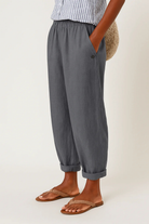 Women's linen pants featuring an elastic waistband and tapered design, perfect for casual wear; breathable and lightweight fabric ideal for warm weather. 4
