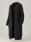 Women's long cardigan sweater featuring a cozy hood and functional pockets, designed with a chunky cable knit pattern and an open front for a stylish and comfortable look. 0