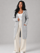 Women's long cardigan sweater featuring a cozy hood and functional pockets, designed with a chunky cable knit pattern and an open front for a stylish and comfortable look. 1