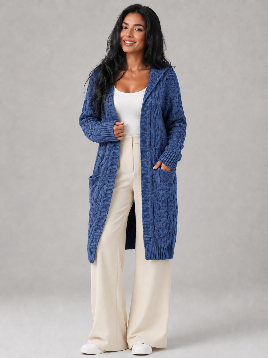 Women's long cardigan sweater featuring a cozy hood and functional pockets, designed with a chunky cable knit pattern and an open front for a stylish and comfortable look. 2