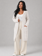 Women's long cardigan sweater featuring a cozy hood and functional pockets, designed with a chunky cable knit pattern and an open front for a stylish and comfortable look. 3