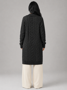 Women's long cardigan sweater featuring a cozy hood and functional pockets, designed with a chunky cable knit pattern and an open front for a stylish and comfortable look. 7