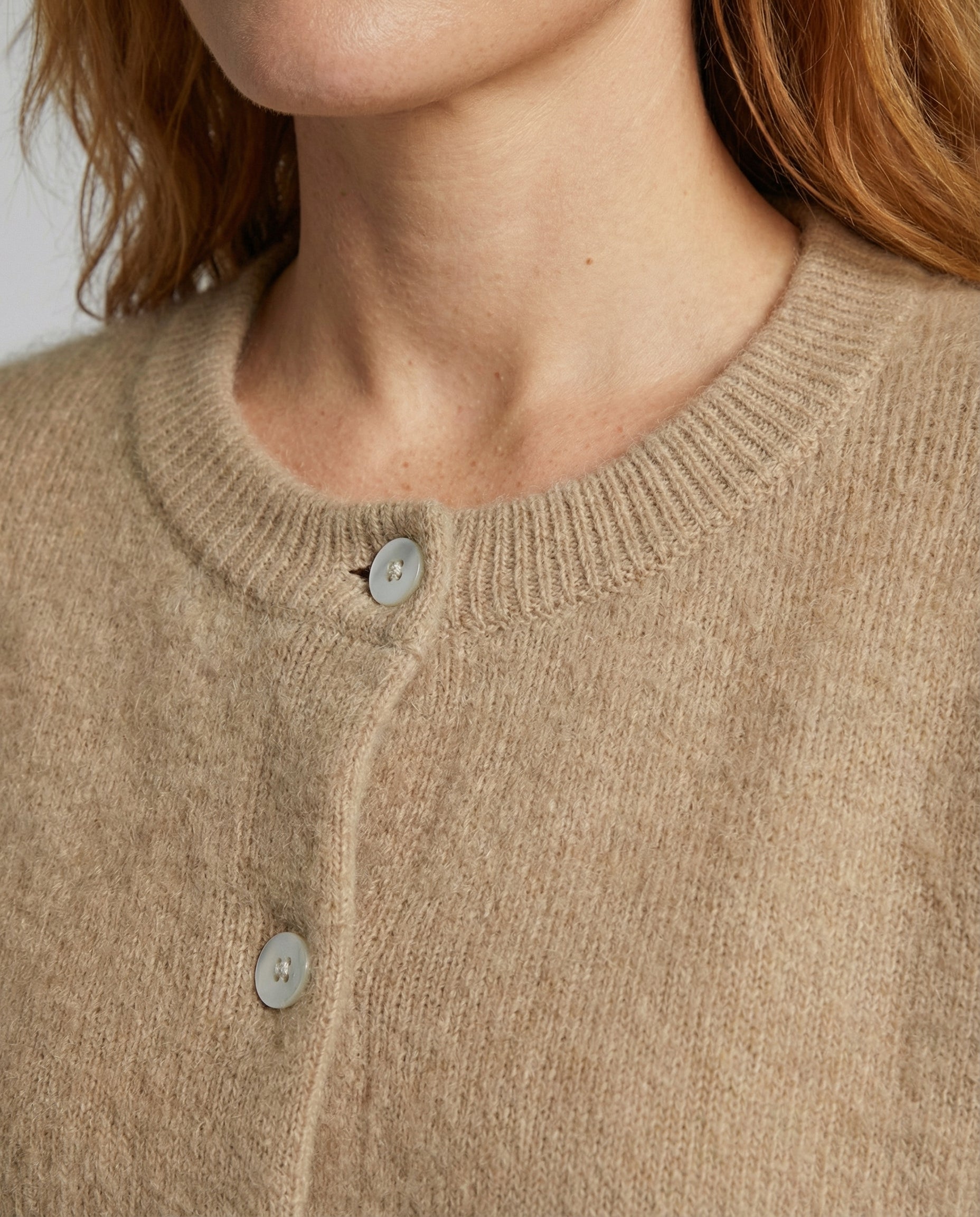 Women's long black cardigan featuring a button front design, crafted from soft brushed knit for comfort and style. 4