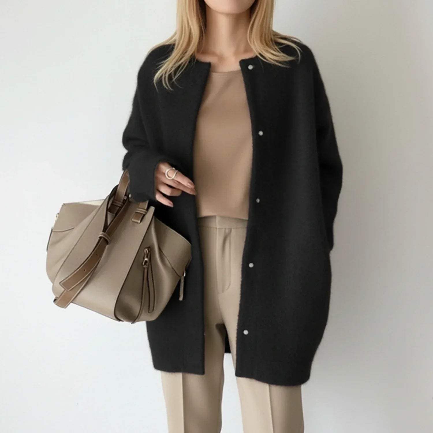 Women's long black cardigan featuring a button front and round neck, perfect for cozy layering in any season. 1