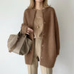 Women's long black cardigan featuring a button front and round neck, perfect for cozy layering in any season. 2