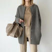 Women's long black cardigan featuring a button front and round neck, perfect for cozy layering in any season. 3
