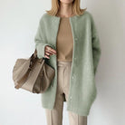 Women's long black cardigan featuring a button front and round neck, perfect for cozy layering in any season. 5