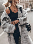 Women's long cardigan featuring deep side pockets and a chunky knit texture, designed with an oversized drop-shoulder silhouette for a cozy, stylish look. 3