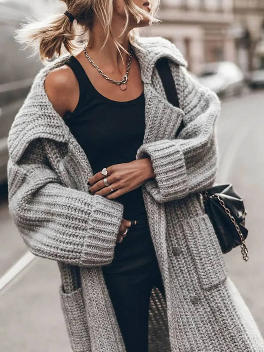 Women's long cardigan featuring deep side pockets and a chunky knit texture, designed with an oversized drop-shoulder silhouette for a cozy, stylish look. 3