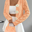 Elegant white women's long cardigan featuring an open crochet design and decorative floral buttons, perfect for layering in any season. 0