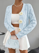 Elegant white women's long cardigan featuring an open crochet design and decorative floral buttons, perfect for layering in any season. 1