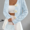 Elegant white women's long cardigan featuring an open crochet design and decorative floral buttons, perfect for layering in any season. 10