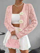 Elegant white women's long cardigan featuring an open crochet design and decorative floral buttons, perfect for layering in any season. 2