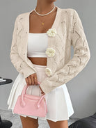 Elegant white women's long cardigan featuring an open crochet design and decorative floral buttons, perfect for layering in any season. 4