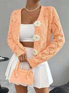 Elegant white women's long cardigan featuring an open crochet design and decorative floral buttons, perfect for layering in any season. 5