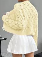 Elegant white women's long cardigan featuring an open crochet design and decorative floral buttons, perfect for layering in any season. 8
