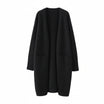 Women's long black cardigan with pockets, featuring a soft knit fabric and relaxed fit, perfect for layering and casual wear. 0