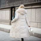 Women's long down puffer coat with high collar, designed for lightweight insulation and warmth, perfect for winter wear. 2