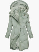 Women's long winter coat featuring a stylish faux fur hood and warming lining, designed for elegance and comfort in cold weather. 0
