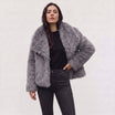 Women's longline faux fur coat featuring an oversized collar and a relaxed open-front design, perfect for stylish winter wear. 8