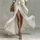 Women’s white boho linen maxi dress featuring long sleeves and a stylish split hem, perfect for summer outings and casual events. 3