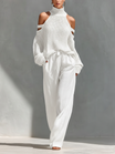 Women's outfit set featuring a beige cold-shoulder knit turtleneck top paired with wide-leg pants, showcasing a modern and comfortable style perfect for casual 3