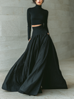 Women's outfit set featuring a fitted turtleneck cropped top and long skirt in black, designed with stretch knit material for a minimalist look. 0