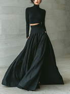 Women's outfit set featuring a fitted turtleneck cropped top and long skirt in black, designed with stretch knit material for a minimalist look. 0