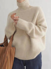 Women's oversized cashmere sweater featuring a cozy turtleneck design, crafted from soft knit fabric for ultimate comfort and warmth. 0