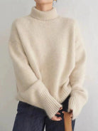 Women's oversized cashmere sweater featuring a cozy turtleneck design, crafted from soft knit fabric for ultimate comfort and warmth. 1