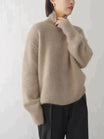 Women's oversized cashmere sweater featuring a cozy turtleneck design, crafted from soft knit fabric for ultimate comfort and warmth. 4