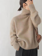 Women's oversized cashmere sweater featuring a cozy turtleneck design, crafted from soft knit fabric for ultimate comfort and warmth. 5