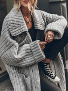 Women's oversized chunky knit cardigan featuring a longline hem and drop-shoulder design, perfect for cozy layering in cooler weather. 4