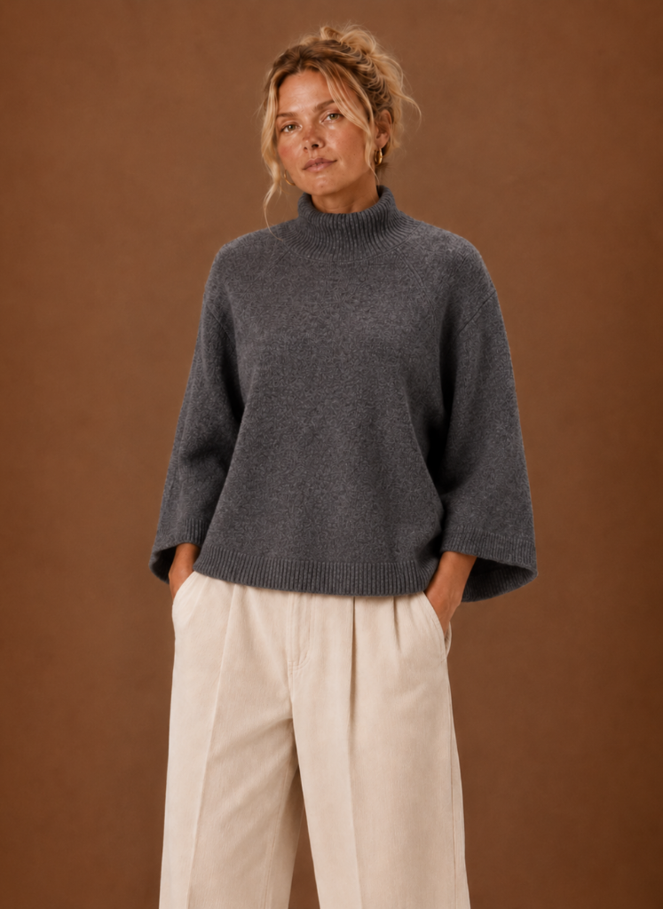 Women's oversized chunky knit sweater featuring a mock neck and bell sleeves, designed for cozy warmth in stylish neutral colors. 0