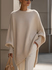 Women's oversized sweater featuring a cozy knit crew neck design and stylish asymmetrical hem, perfect for casual and comfortable outfits. 0