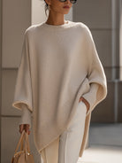 Women's oversized sweater featuring a cozy knit crew neck design and stylish asymmetrical hem, perfect for casual and comfortable outfits. 0