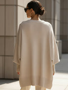 Women's oversized sweater featuring a cozy knit crew neck design and stylish asymmetrical hem, perfect for casual and comfortable outfits. 6