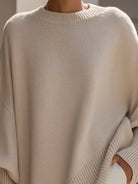 Women's oversized sweater featuring a cozy knit crew neck design and stylish asymmetrical hem, perfect for casual and comfortable outfits. 7