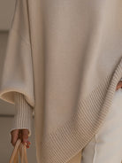 Women's oversized sweater featuring a cozy knit crew neck design and stylish asymmetrical hem, perfect for casual and comfortable outfits. 8