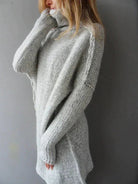 Women's oversized grey sweater featuring a chunky knit texture and high roll neck, perfect for cozy fall and winter outfits. 2