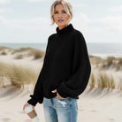Women’s oversized sweater featuring a cozy turtleneck design, crafted from soft acrylic material, perfect for a boho chic look. Ideal for casual wear 2