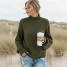 Women’s oversized sweater featuring a cozy turtleneck design, crafted from soft acrylic material, perfect for a boho chic look. Ideal for casual wear 3