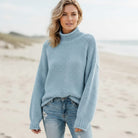 Women’s oversized sweater featuring a cozy turtleneck design, crafted from soft acrylic material, perfect for a boho chic look. Ideal for casual wear 6