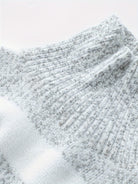 Women's oversized sweater in classic grey, featuring a high neckline and cozy knit design, perfect for casual outings and chilly days. 6