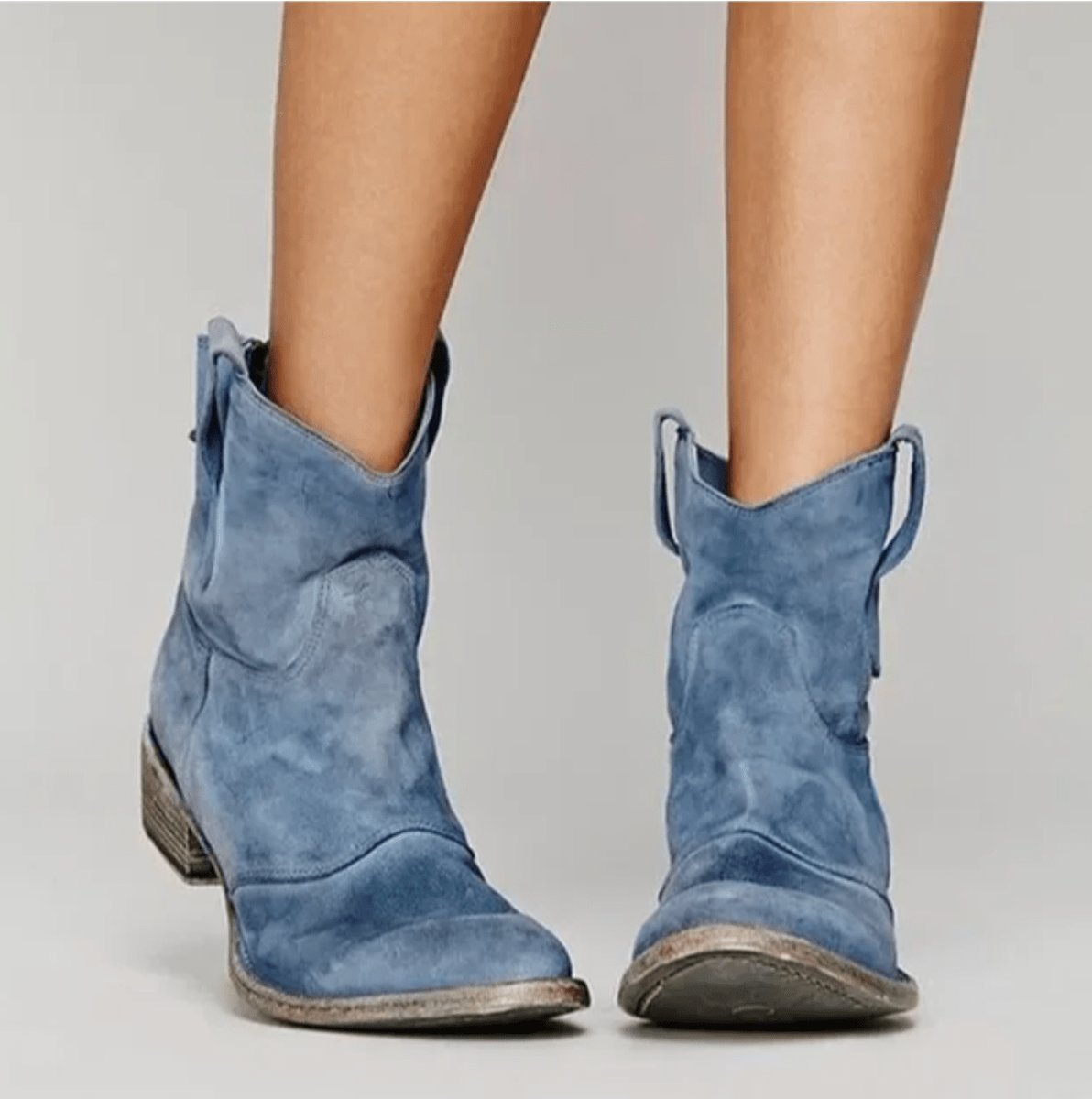 Women’s suede ankle boots featuring a flat heel and stylish western stitching, perfect for versatile all-day wear. 0