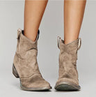 Women's suede western boots featuring a low heel and round toe, perfect for versatile everyday wear and stylish comfort. 0