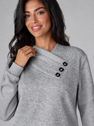 Women's sweater featuring an asymmetric shawl collar and stylish button detail, crafted from soft textured knit for ultimate comfort and warmth. 2