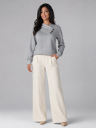 Women's sweater featuring an asymmetric shawl collar and stylish button detail, crafted from soft textured knit for ultimate comfort and warmth. 7
